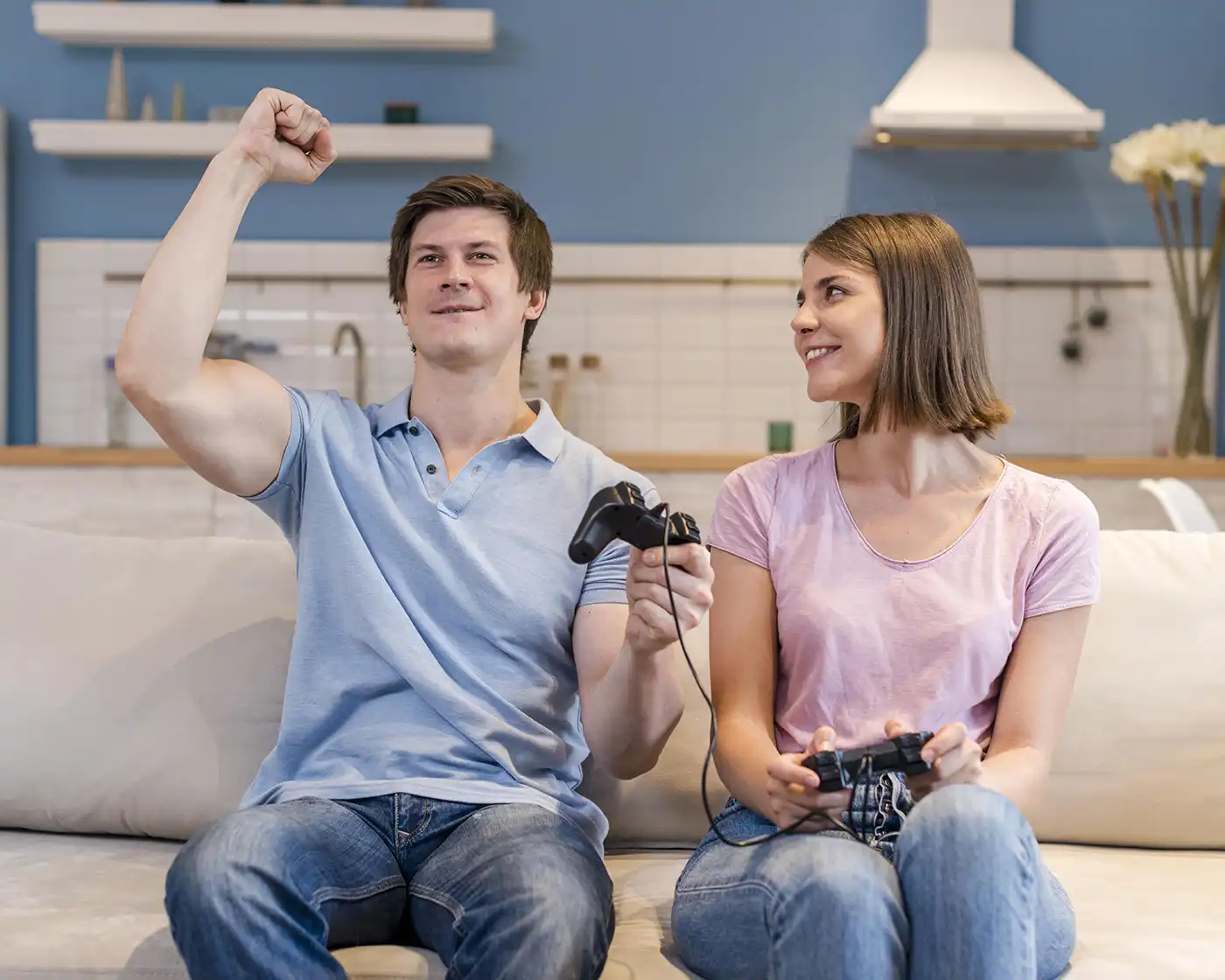 Couple playing video games at home