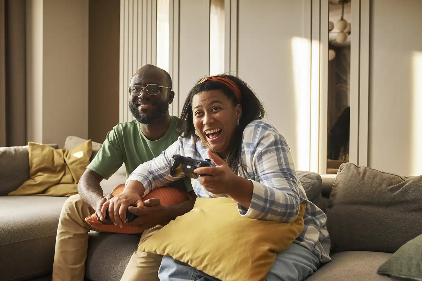 Couple playing video games at home