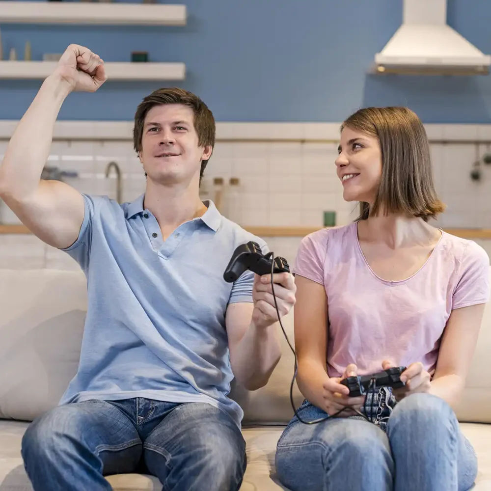 Couple playing video games at home